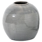 Grey rounded vase with a low circular opening, fine crackle pattern and dark patches at the rim and base, shown against white.
