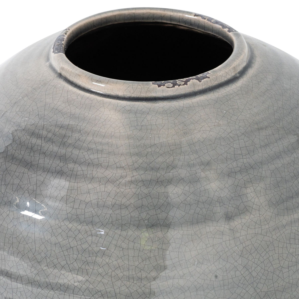 Close-up of the vase's wide opening and curved shoulder, showing dense crackle lines and irregular dark marks along the rim.