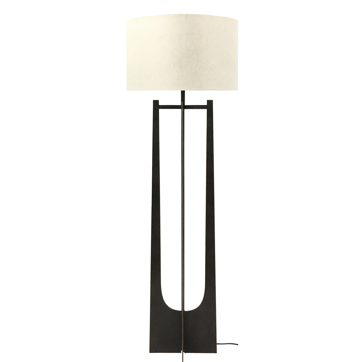 Front view of the Lunette Floor Lamp with a pale cylindrical shade and tall dark base with elongated curved openings.