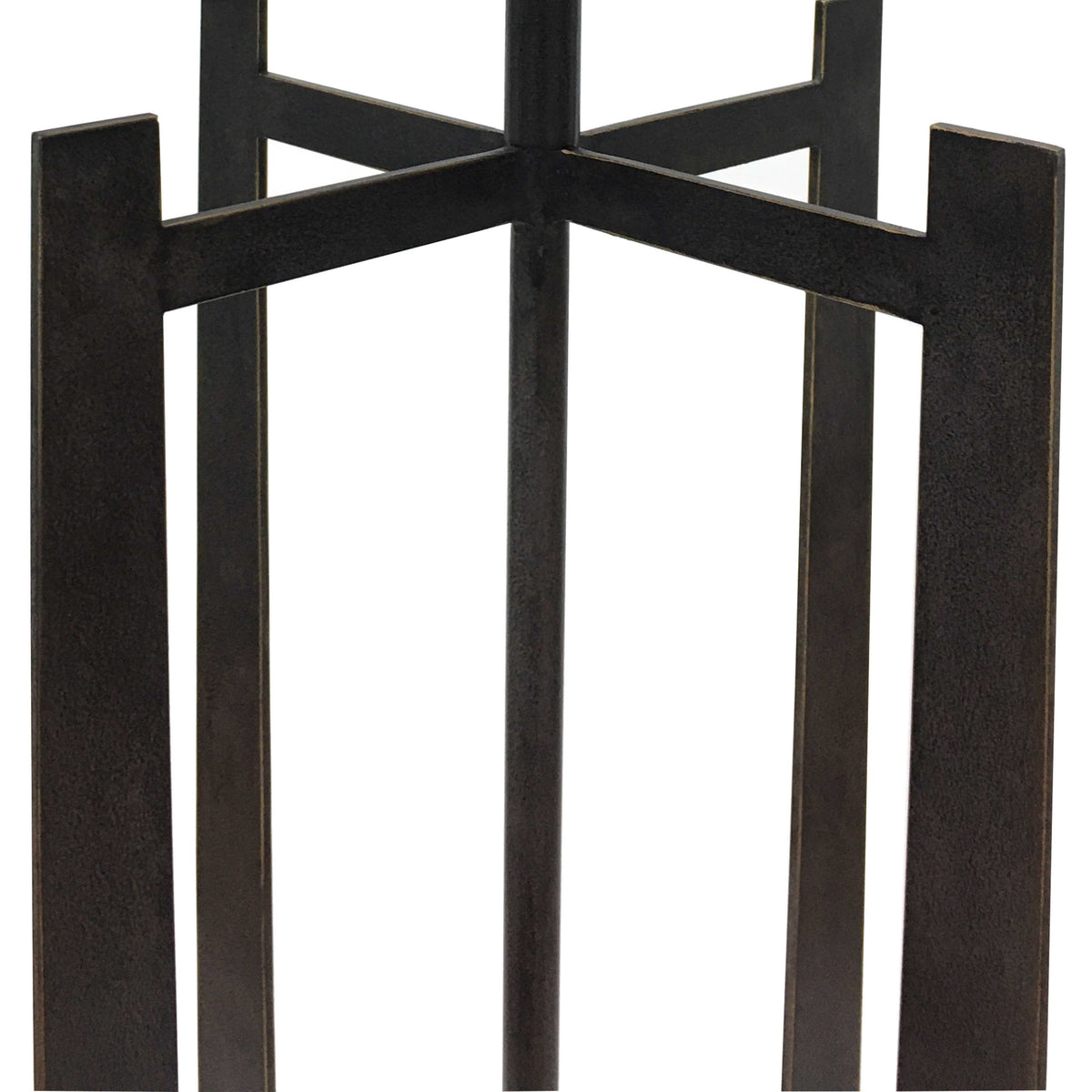 Close-up of the dark textured iron uprights and intersecting horizontal fins around the lamp's central stem.
