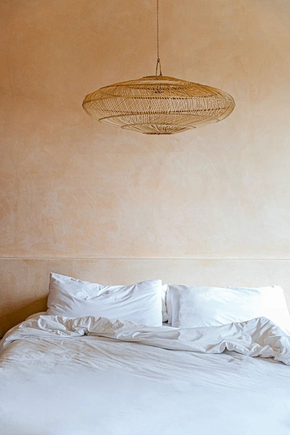 Macaron Rattan Pendant Light – Natural, Large – styled above a bed