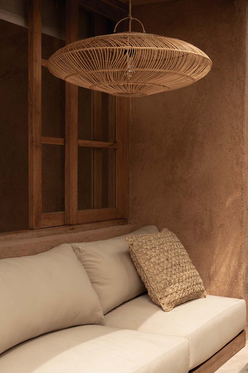 Macaron Rattan Pendant Light – Natural, Medium – styled above a built-in sofa