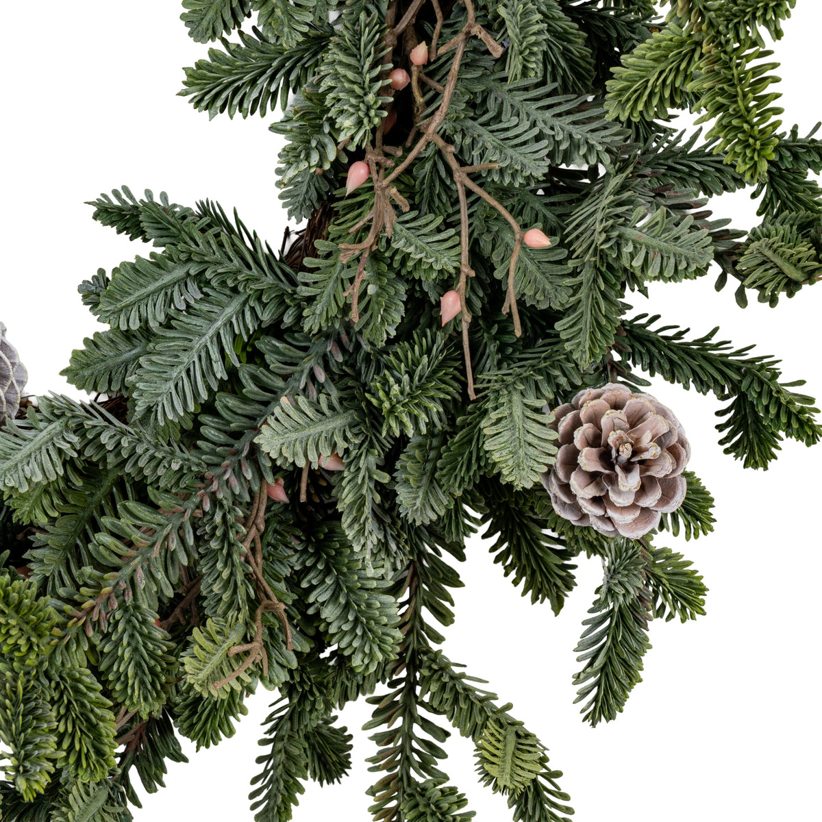 Wreath detail showing a rounded pale-edged pinecone beside overlapping grey-green sprays and brown branching stems with small pink bud-like accents.