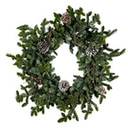 Full view of a circular artificial wreath with an open centre, mixed green fir-like sprays, pale-edged pinecones and small pink-orange accents on white.