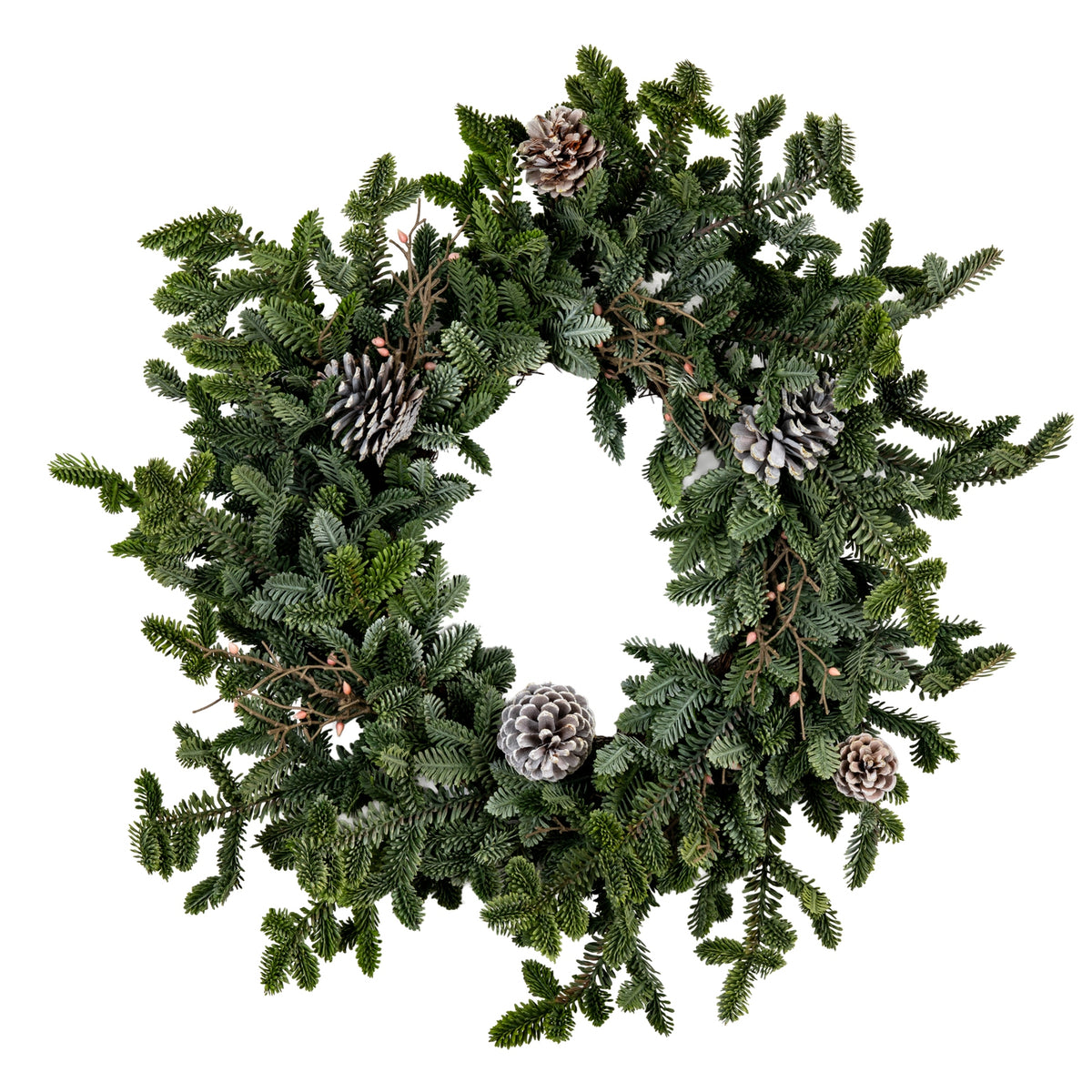 Full view of a circular artificial wreath with an open centre, mixed green fir-like sprays, pale-edged pinecones and small pink-orange accents on white.