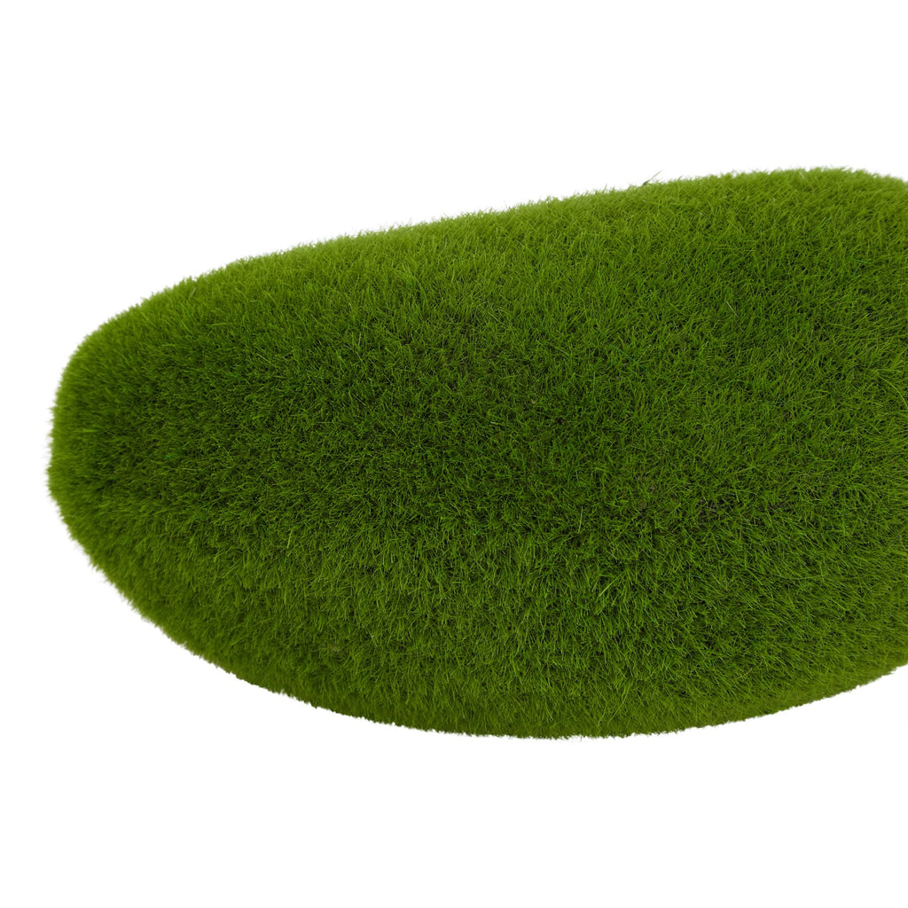 Close-up of a green artificial moss mound, showing fine short fibres across its curved surface.