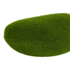 Close-up of a green artificial moss mound, showing fine short fibres across its curved surface.