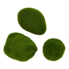 Overhead view of three green moss-effect pieces, showing their differing rounded outlines and dense fibrous surfaces.