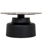 Front view of a round coffee table with a slim mottled top and a black pedestal that curves out to a broad base.