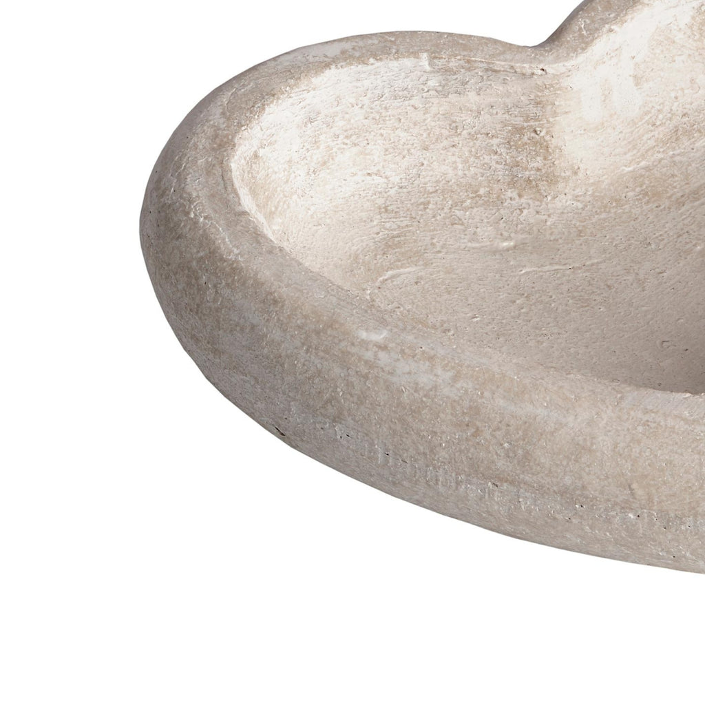 Close-up of the dish's curved rim and inner well, showing pale mottling and a lightly pitted texture.