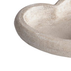 Close-up of the dish's curved rim and inner well, showing pale mottling and a lightly pitted texture.