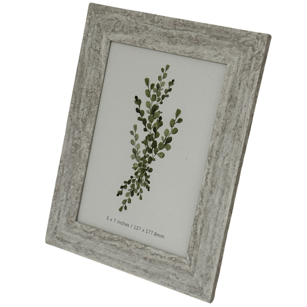 Angled front view of a pale grey-beige mottled photo frame with a broad ridged border surrounding a green botanical insert.