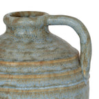 Close-up of the vase loop handle and rolled rim, with warm-brown ridges crossing the mottled blue-grey shoulder.