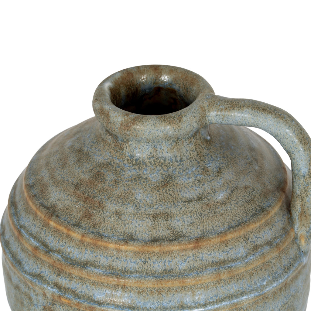 View from above of the jug vase opening, showing the thick rounded lip and blue-grey and brown mottling across the shoulder.