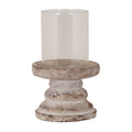 Candle lantern with an open transparent cylinder in a wide raised-edged dish, above a stepped grey-beige pedestal with brown mottling, on a white background.