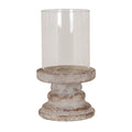 Candle lantern on a white background, with a tall clear open cylinder above a shallow dish and stepped pale grey-beige pedestal with brown speckling.
