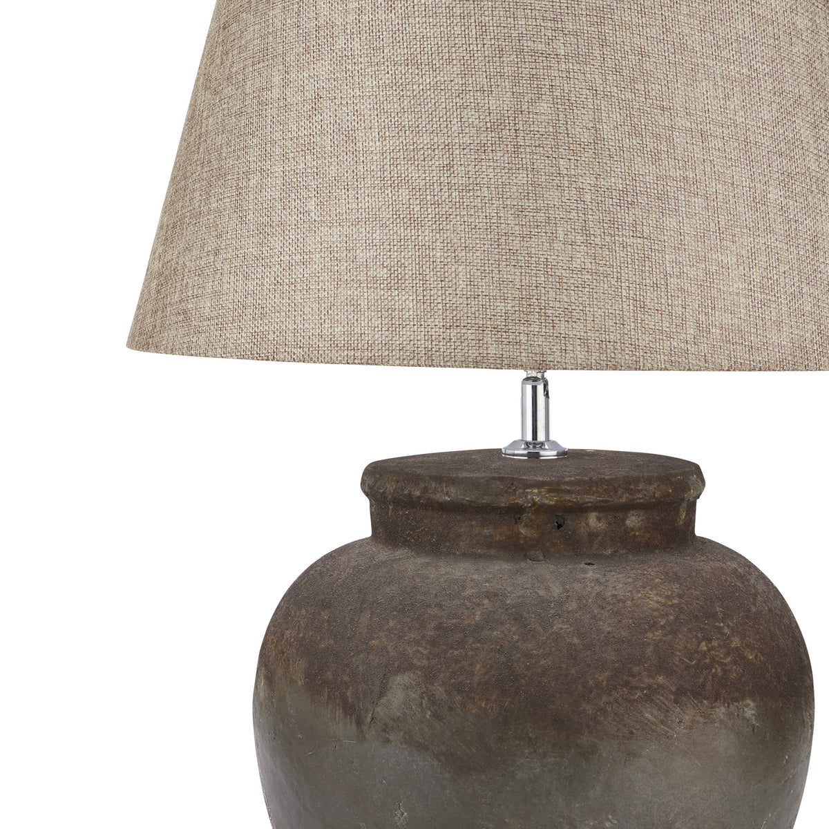 Close-up of the beige shade's weave-like texture above the broad pot lip and dark mottled surface of the lamp base.