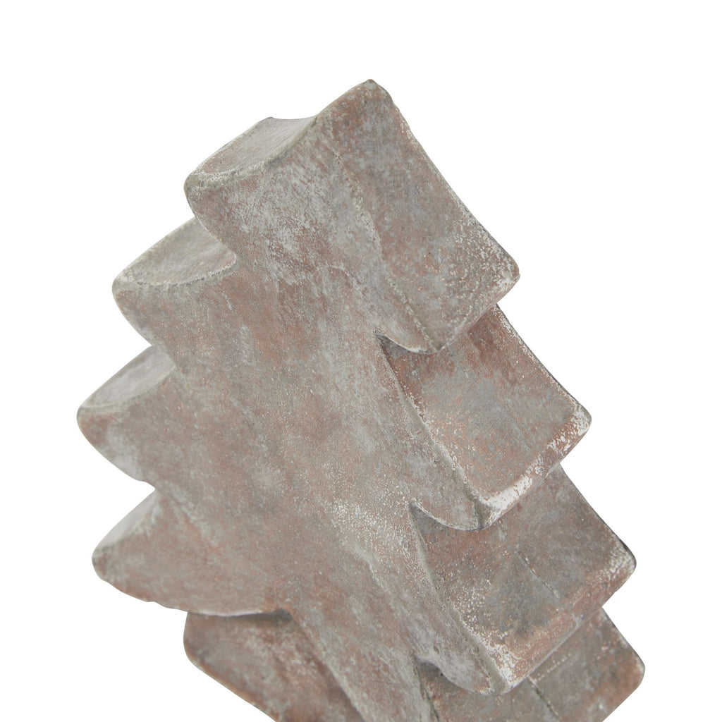 Angled close-up of the tree ornament's pointed top and thick curved tiers, showing pale mottling across the brown surface.