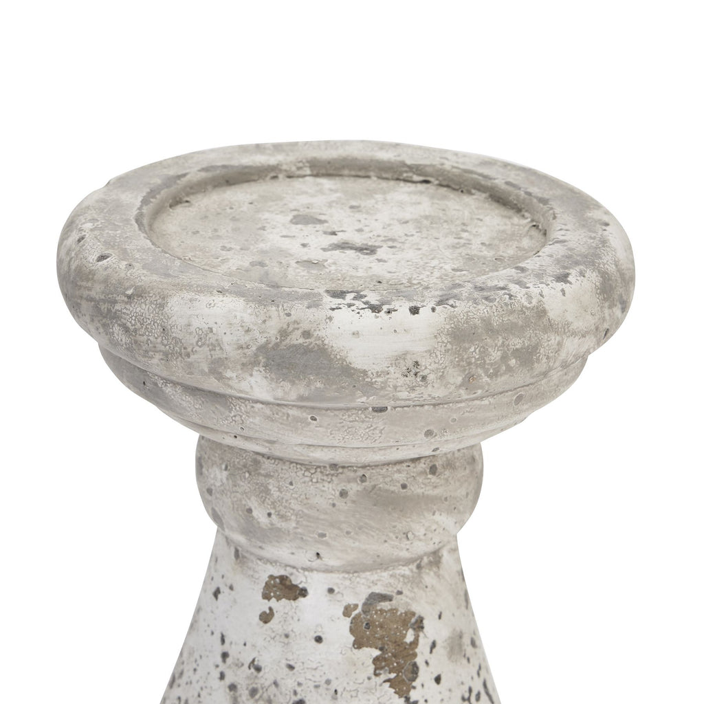 Close-up of the candle holder's shallow recessed top and rounded rim, with pitted texture and darker patches visible on the neck.
