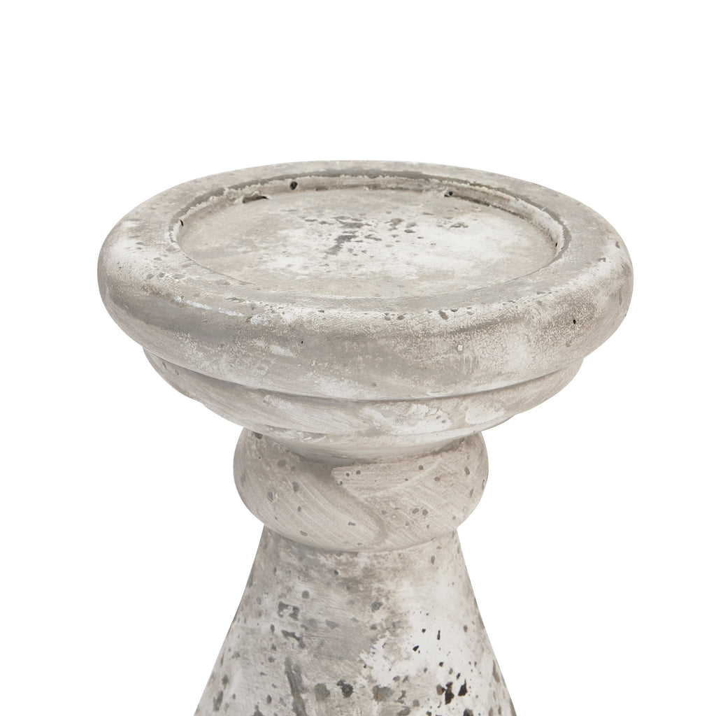 Close-up of the candle holder's recessed circular top and rounded upper collar, showing pale mottling, small pits and darker surface flecks.
