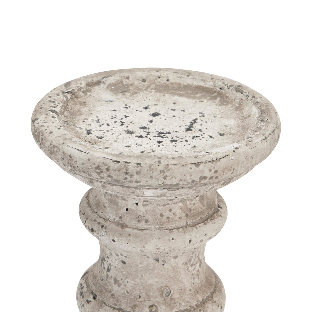 Close-up of the candle holder's broad shallow top recess, showing grey and charcoal mottling, pits and rubbed pale patches.