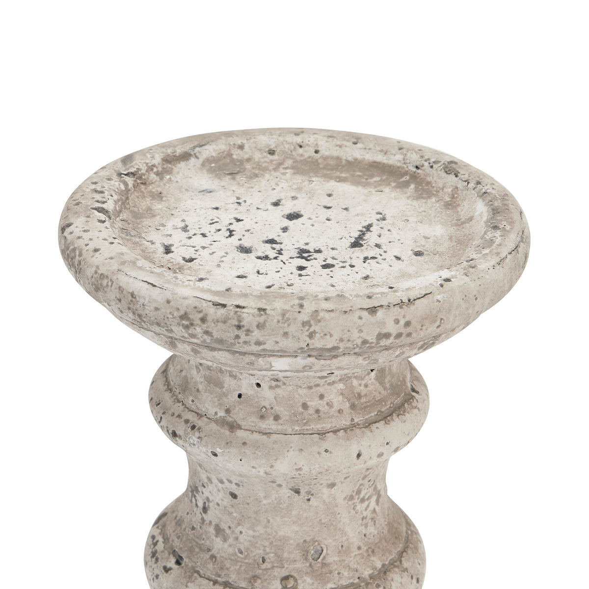 Close-up of the candle holder's broad shallow top recess, showing grey and charcoal mottling, pits and rubbed pale patches.