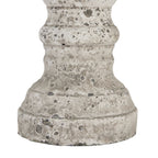 Close-up of the candle holder's lower curves and stepped foot, showing dark grey mottling, small pits and rubbed pale patches.