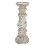 Pale mottled candle holder with a shallow round top, bulbous central section and stepped circular foot against a white background.