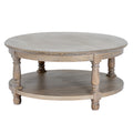 Round brown coffee table with a broad grained top, shaped rim, four turned-profile legs and a circular lower shelf on a white background.