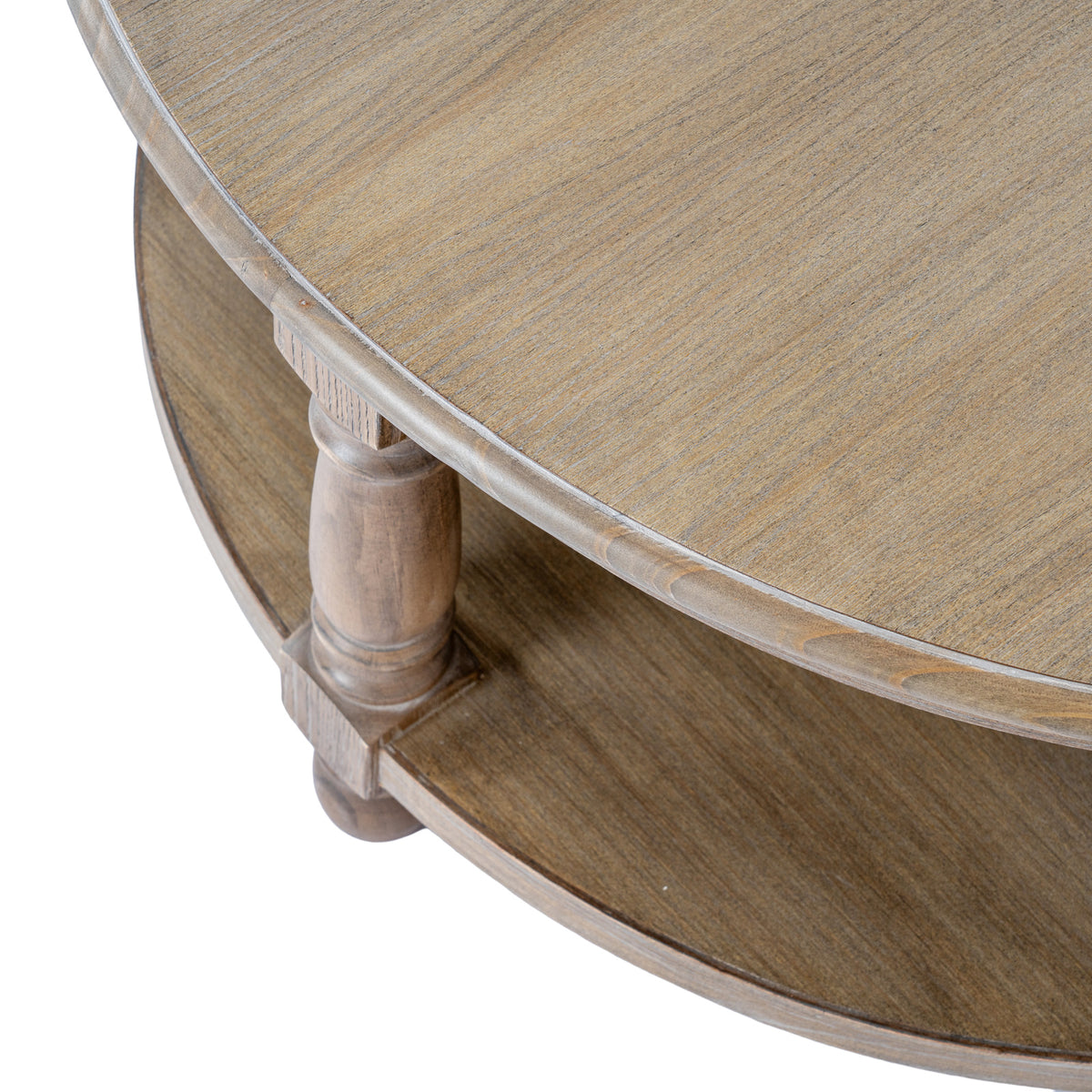 Angled detail looking down across the grained circular tabletop and shaped rim, with a rounded leg and the lower shelf visible beneath.