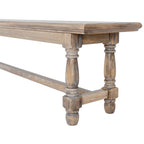 Detail of one end of the brown bench showing the moulded seat edge, shallow apron, shaped legs and low end stretcher.