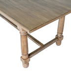 Close view of a tabletop corner with its layered edge profile, two rounded brown legs and low end stretcher.