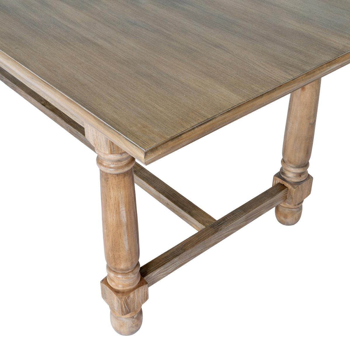 Close view of a tabletop corner with its layered edge profile, two rounded brown legs and low end stretcher.