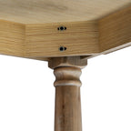 Underside corner detail showing two dark circular fittings in the apron and the rounded upper profile of a brown table leg.