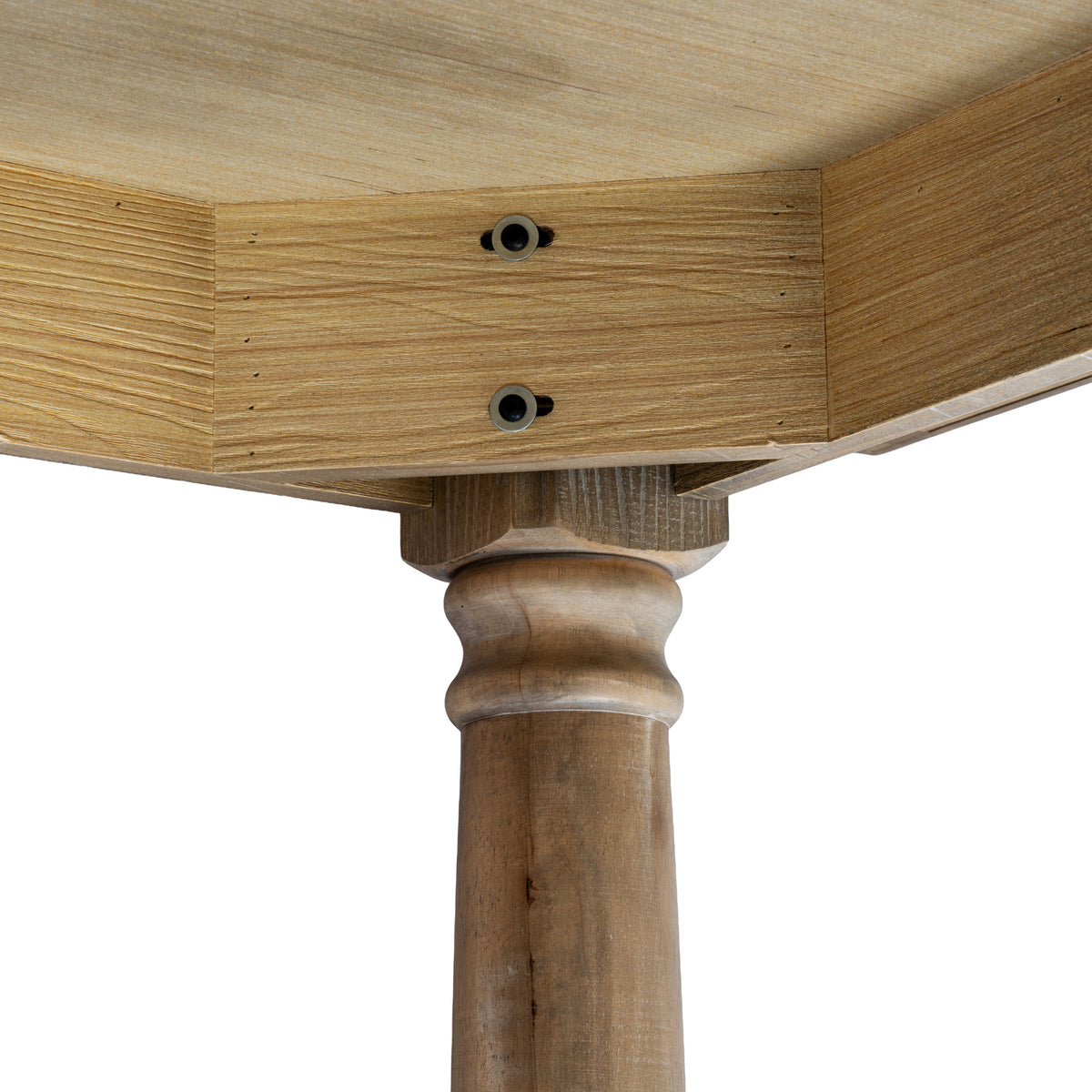 Underside corner detail showing two dark circular fittings in the apron and the rounded upper profile of a brown table leg.