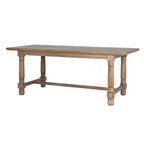 Three-quarter view of the brown rectangular dining table, showing its shaped overhanging top, four turned-profile legs and low connecting rails.
