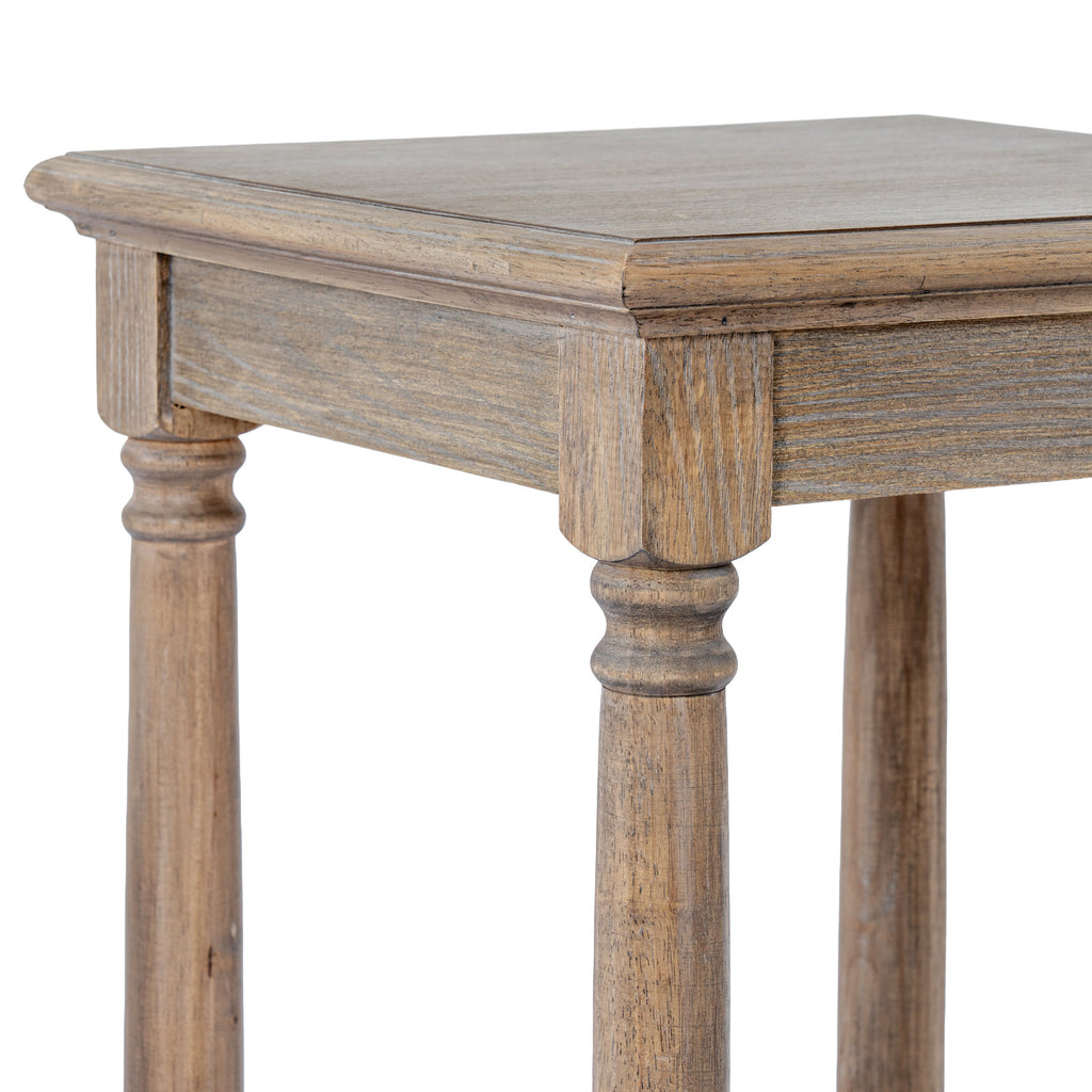 Close-up of the side table's square top corner, showing the contoured edge, shallow apron and curved detail at the top of the legs.