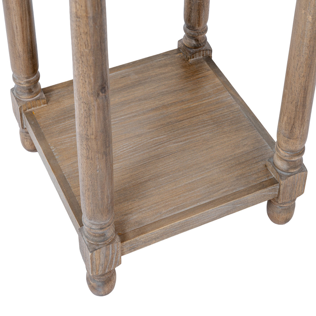 Close-up looking down onto the low square shelf between the table legs, with pale surface streaks, turned lower details and rounded feet.