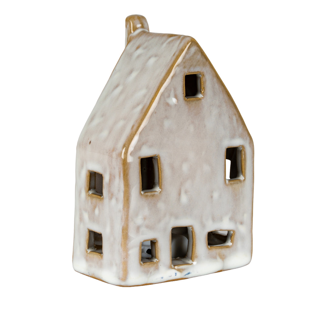 Front and left-side view of the house decoration, showing tan-edged window cut-outs and mottling across the glossy pale surface.