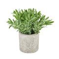 Artificial plant with dense elongated green leaves spreading above a cylindrical grey-beige stone-effect pot on a white background.