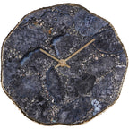 Front view of the mantel clock showing its dark patterned agate face, plain hands and uneven gold-coloured border.
