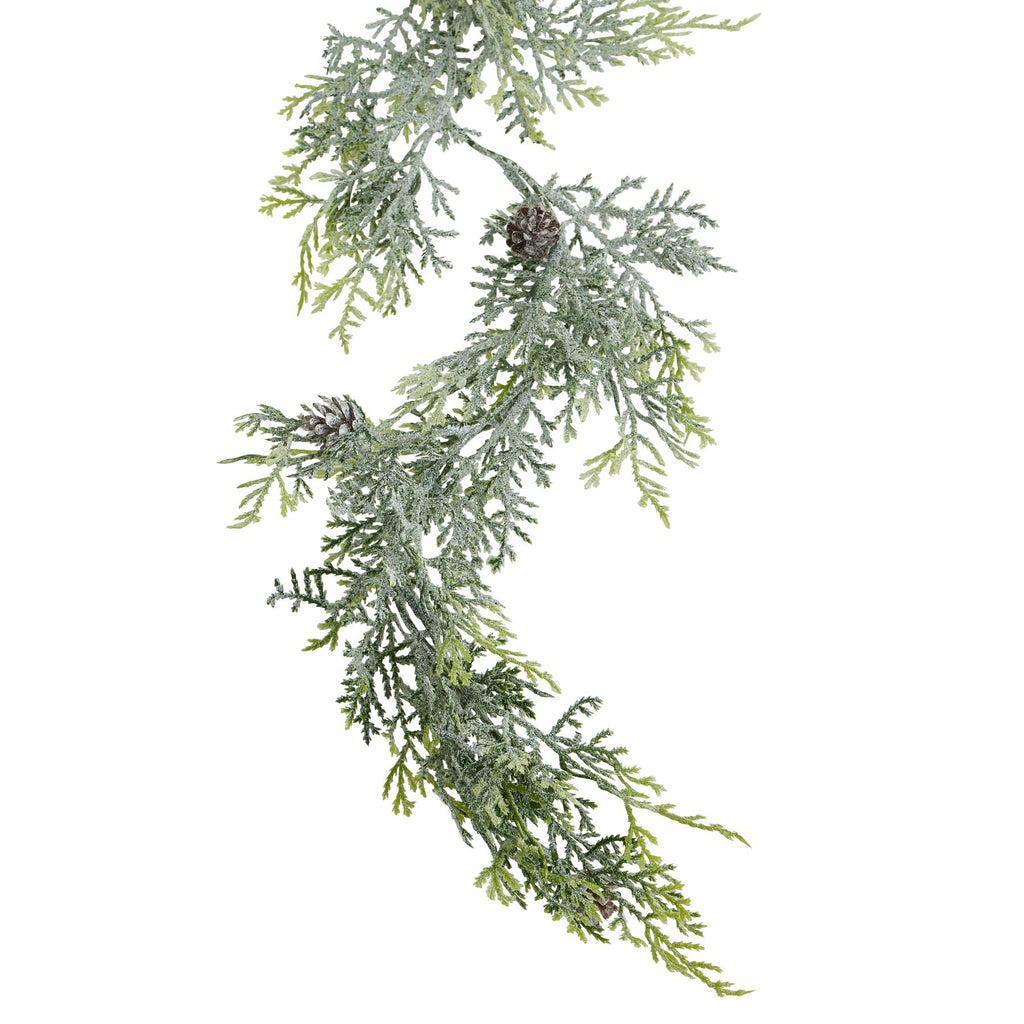 Close-up of the garland's pale frosted foliage, lighter green tips and brown pinecones against a white background.
