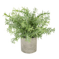Artificial plant with dense narrow green leaves and spreading stems in a cylindrical mottled grey pot against a white background.