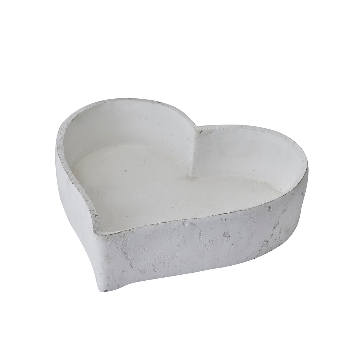 Single white heart-shaped dish viewed at an angle, showing its open interior, low walls and rough rim.
