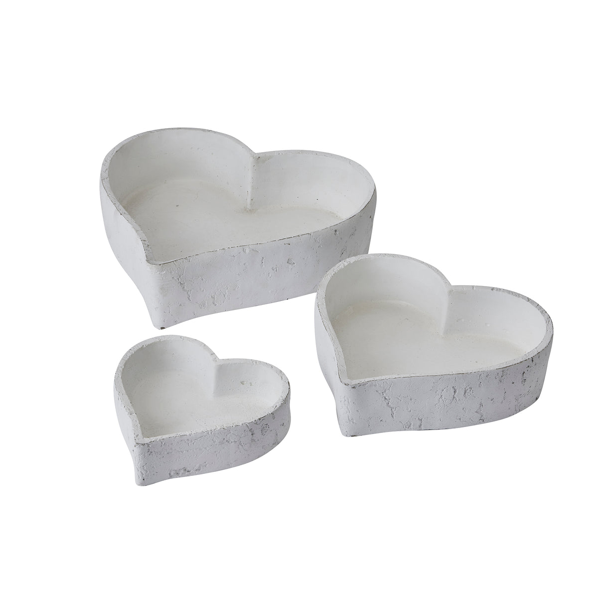 Three graduated white heart-shaped dishes displayed separately, with open interiors and textured outer walls.