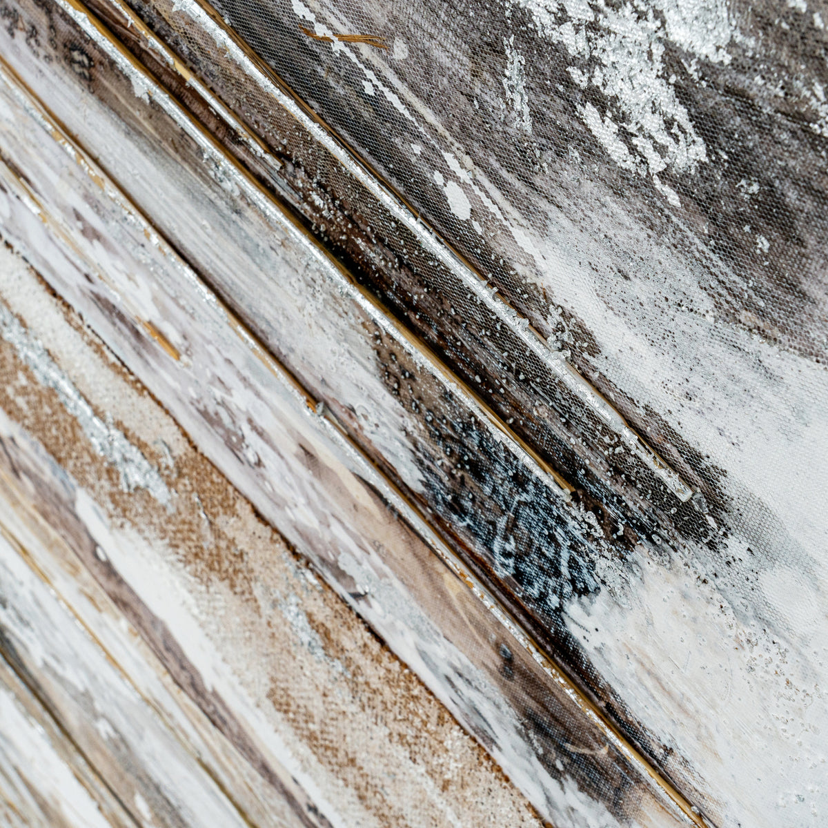 Oblique detail of the abstract surface showing fine ochre lines, white splashes, dark brown patches and visible texture.