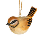 Close-up of the bird decoration showing its glossy black eye, textured ochre and cream finish, striped raised tail and brass-coloured screw eye holding the cord.