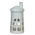 Front view of a white lighthouse tea light holder with three tiers of cut-out windows, a conical roof and an offset chimney.