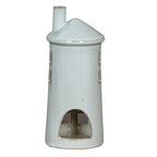 Rear view of the white lighthouse holder showing a large arched opening into the hollow tower and brown edging along the base.