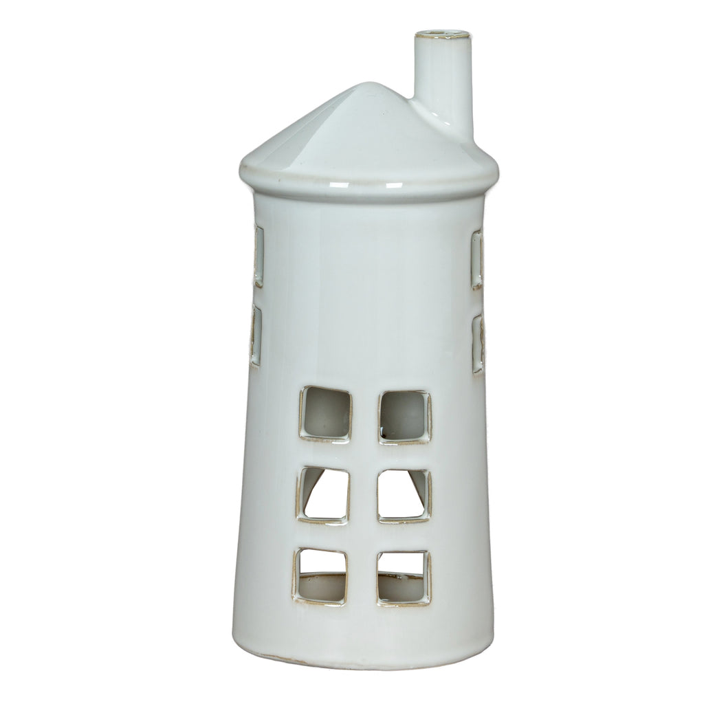 Front view of a white lighthouse tea light holder with rows of square windows, a conical roof and an offset chimney.
